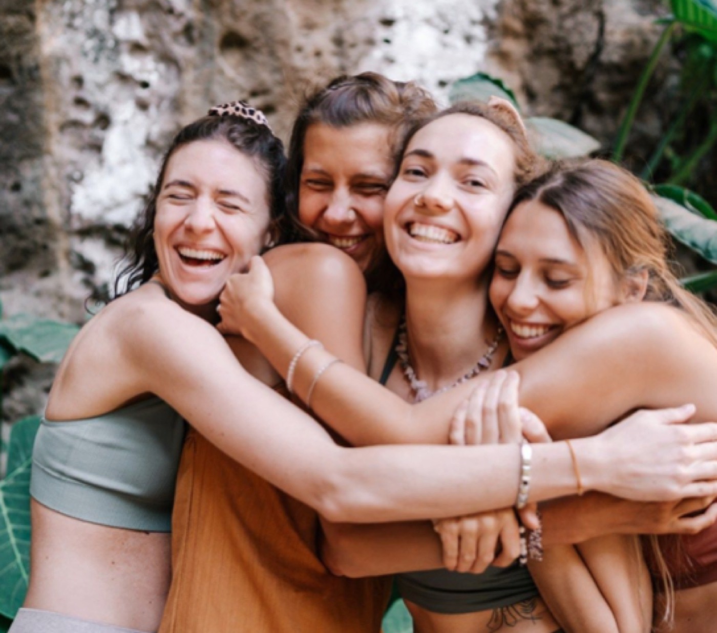 Four students laughing and embracing during the training.
