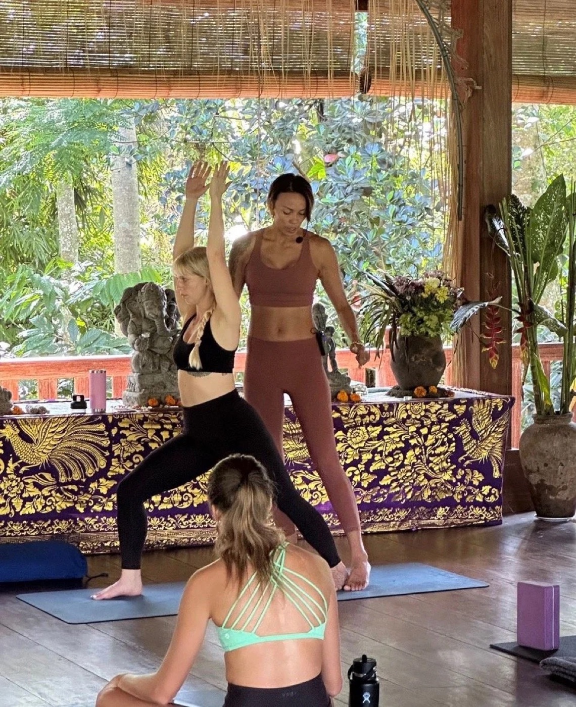Kimberley assisting a student in a standing balance pose during practice teaching.